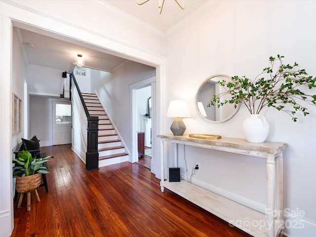 foyer entrance featuring visible vents, ornamental molding, wood-type flooring, baseboards, and stairs