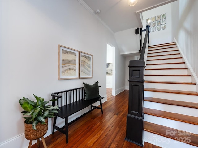 stairway featuring hardwood / wood-style flooring and crown molding