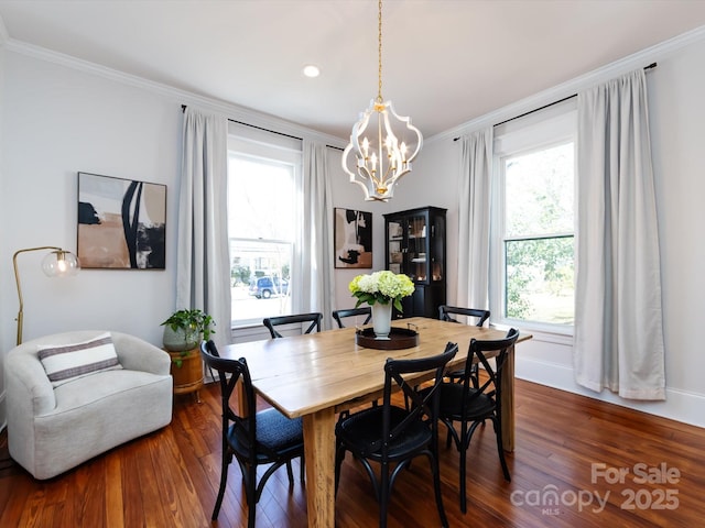 dining area featuring a chandelier, baseboards, dark wood-style floors, and ornamental molding