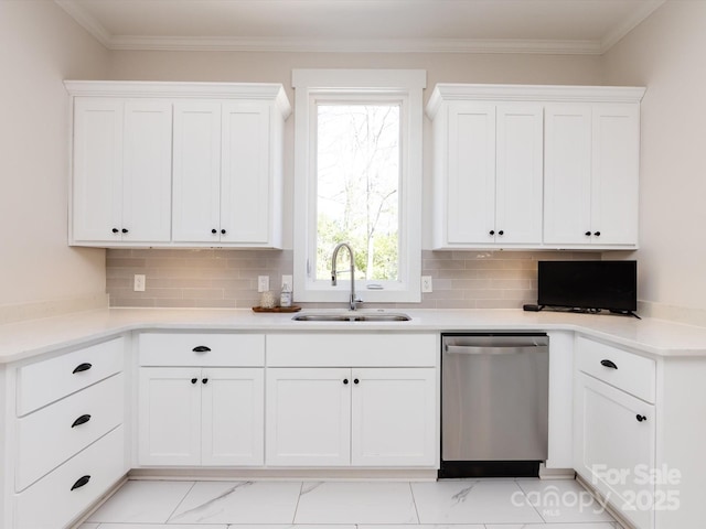 kitchen with decorative backsplash, white cabinets, dishwasher, and a sink