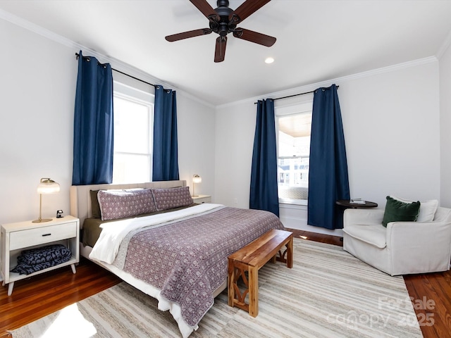 bedroom featuring ornamental molding, ceiling fan, and wood finished floors