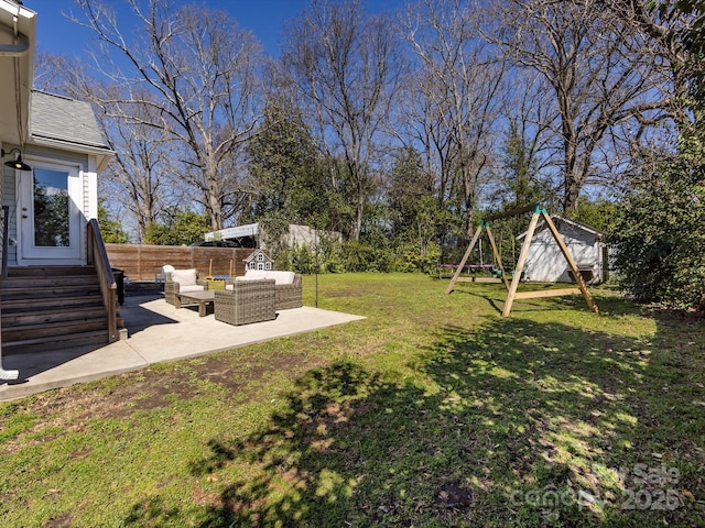 view of yard with entry steps, a patio, fence, a playground, and an outdoor hangout area