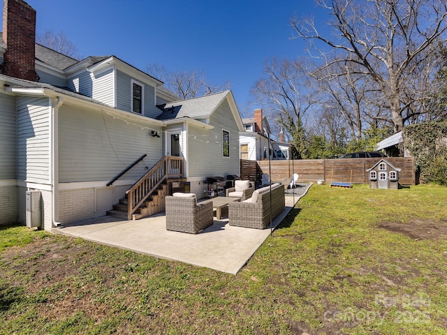 back of house with a patio area, a lawn, an outdoor hangout area, and fence