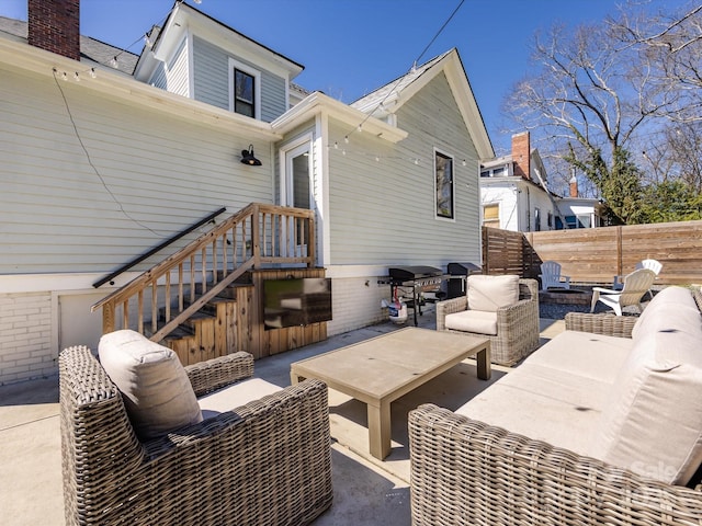 view of patio / terrace with an outdoor living space, a grill, and fence