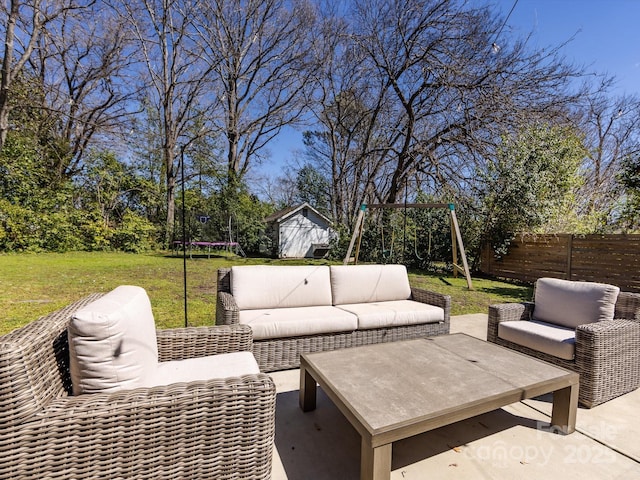 view of patio with a trampoline, a playground, fence, an outdoor structure, and an outdoor hangout area