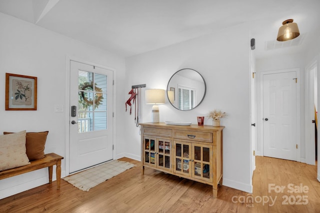 entryway featuring wood finished floors and baseboards