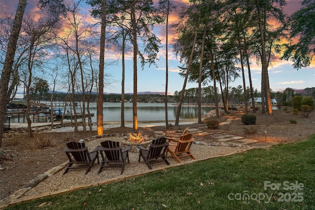 view of patio featuring an outdoor fire pit and a water view