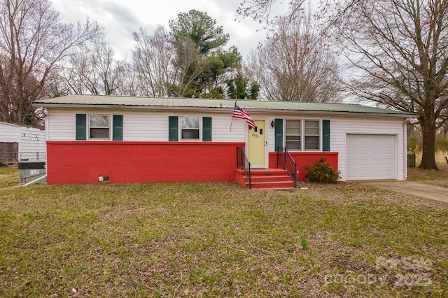 ranch-style home with brick siding, a front lawn, concrete driveway, metal roof, and an attached garage