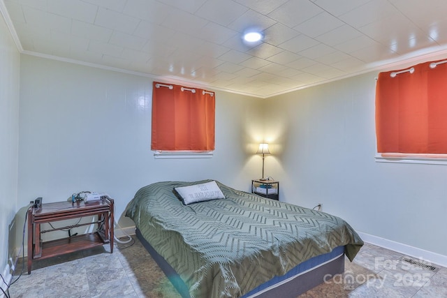 bedroom with visible vents, baseboards, and ornamental molding