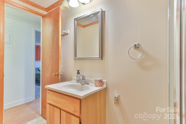 bathroom featuring ornamental molding and vanity