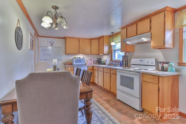 kitchen with white appliances, a sink, light countertops, under cabinet range hood, and crown molding