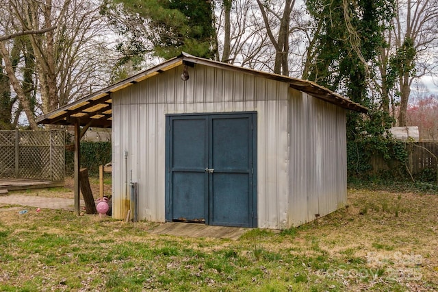 view of shed featuring fence