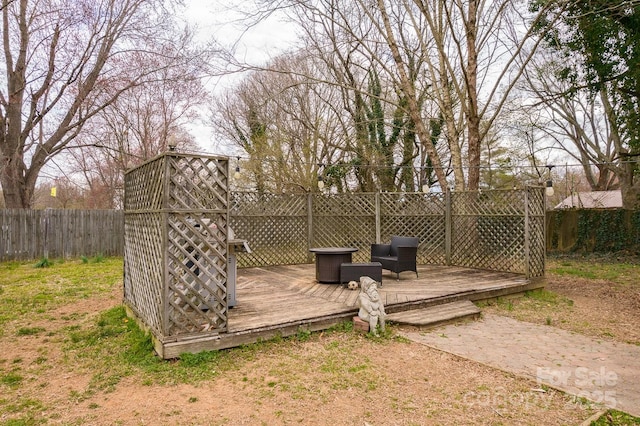 wooden terrace featuring a fenced backyard