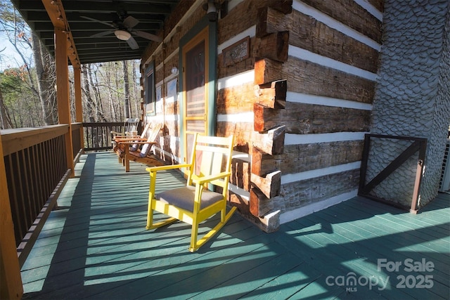 wooden terrace with a ceiling fan