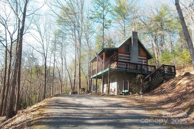 151 Pinewood Dr, Murphy, NC 28906 - view of side of home with a forest view, stairway, a wooden deck, log siding, and a chimney
