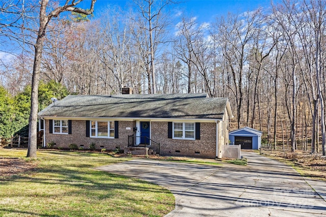 view of front facade featuring an outbuilding, driveway, a front lawn, crawl space, and a detached garage