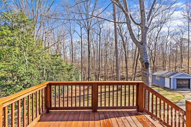 wooden deck with a garage and an outdoor structure