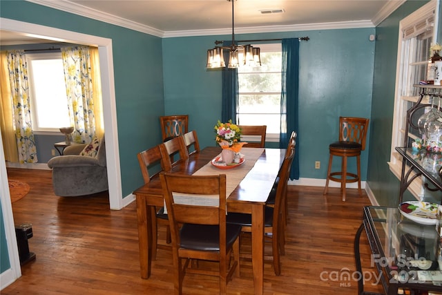 dining space featuring visible vents, a healthy amount of sunlight, wood finished floors, and ornamental molding