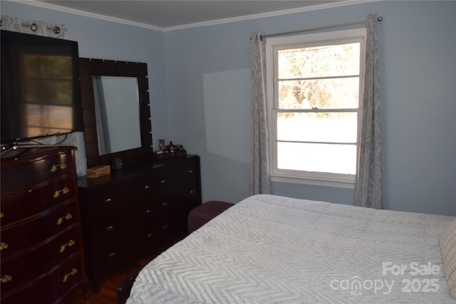 bedroom featuring multiple windows and crown molding