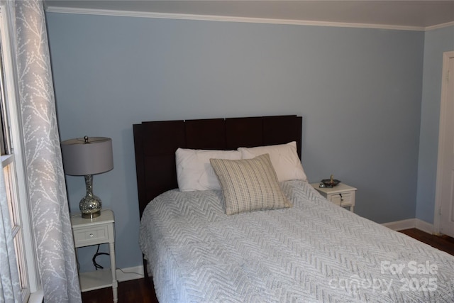 bedroom with dark wood-style floors, baseboards, and ornamental molding