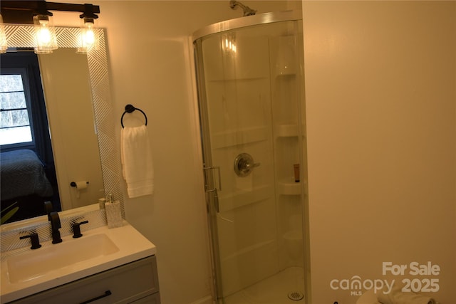 ensuite bathroom with ensuite bath, a shower stall, and vanity