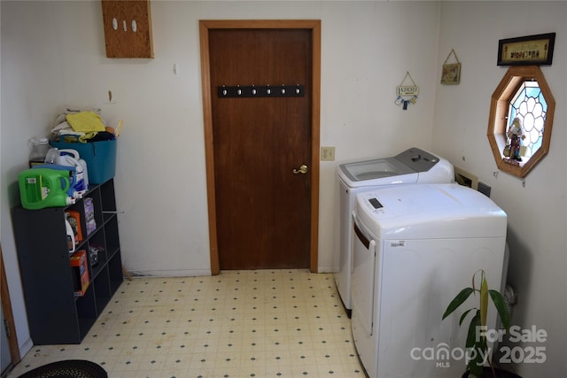 washroom with laundry area, independent washer and dryer, and light floors