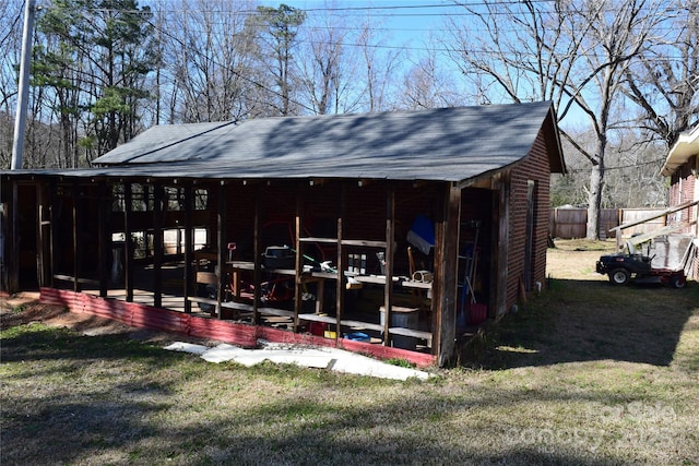 exterior space with an outdoor structure and fence