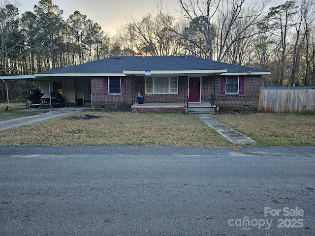 630 Fagan Rd, Winnsboro, SC 29180 - ranch-style house featuring driveway, a carport, fence, a yard, and brick siding