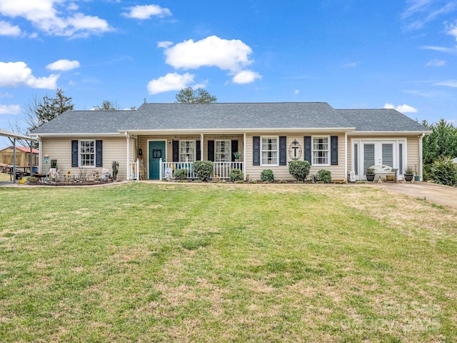 single story home featuring french doors, roof with shingles, a porch, and a front yard