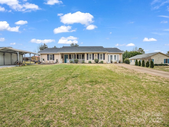 single story home with a detached carport, a front yard, a porch, and driveway