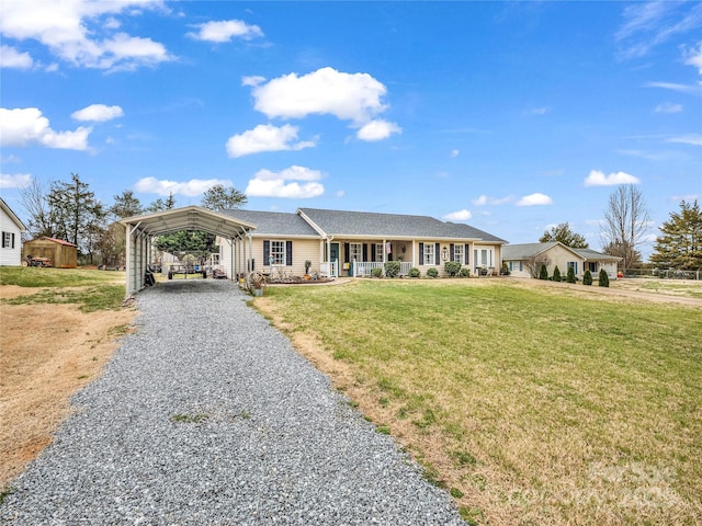 single story home featuring a carport, a front lawn, a porch, and driveway