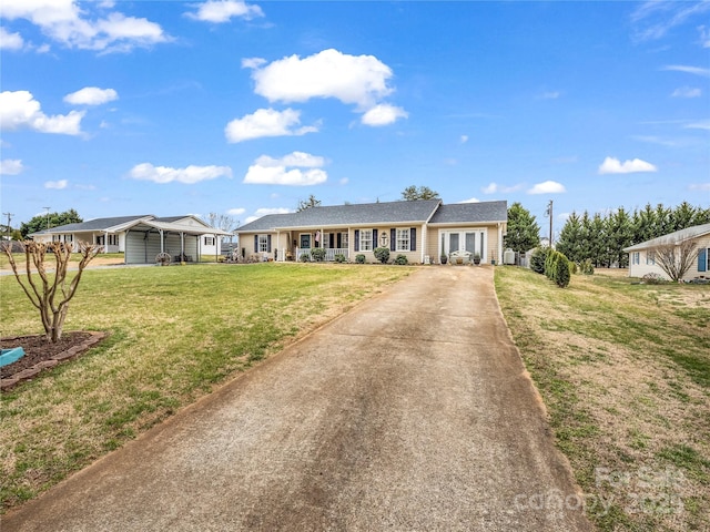 ranch-style home featuring driveway and a front yard