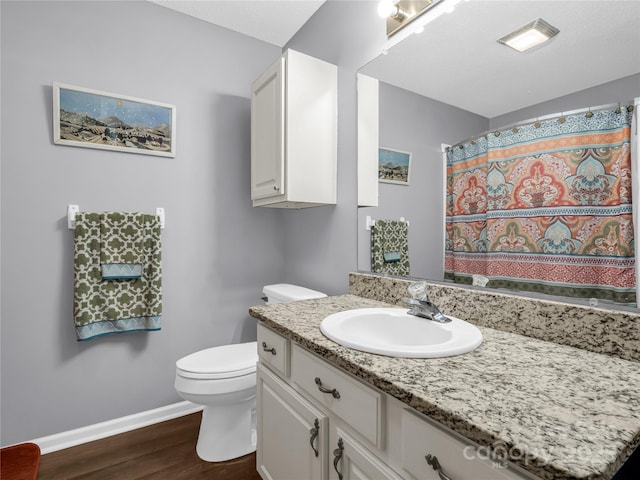 full bathroom featuring vanity, toilet, wood finished floors, and baseboards