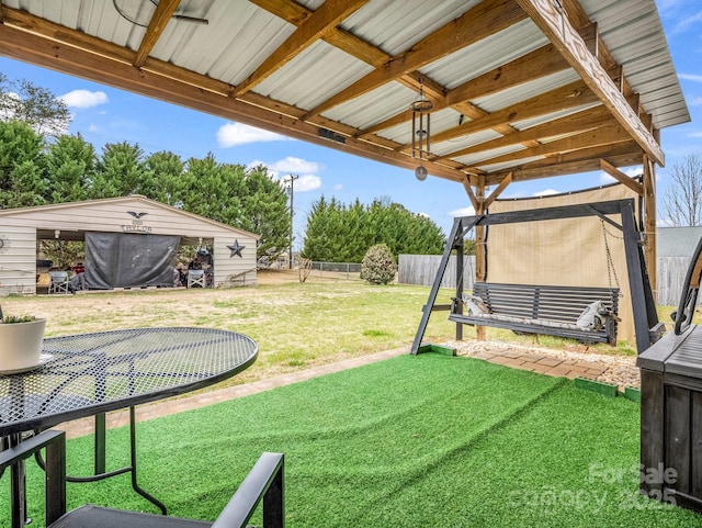 view of yard with an outbuilding and fence