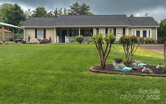 ranch-style house with covered porch, a front yard, and roof with shingles