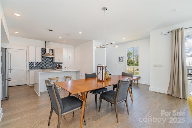 dining space featuring recessed lighting, visible vents, and light wood finished floors