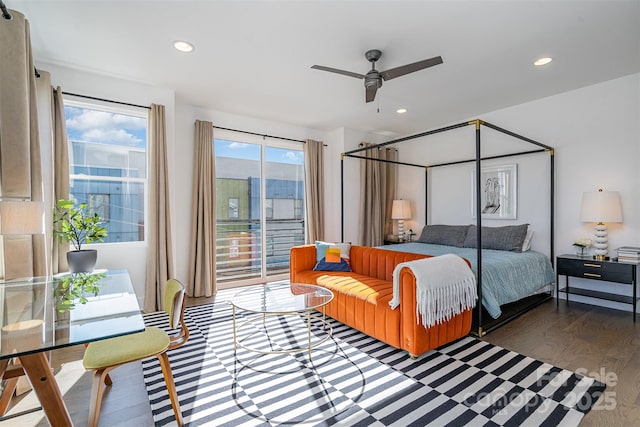 bedroom with wood finished floors, access to exterior, and recessed lighting