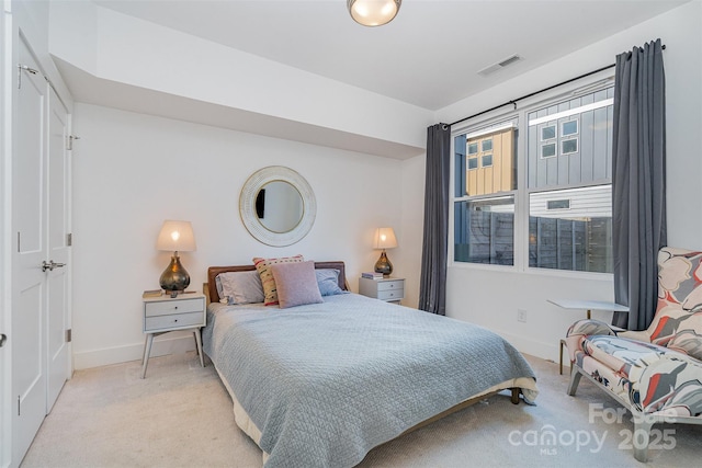bedroom featuring baseboards, visible vents, and carpet