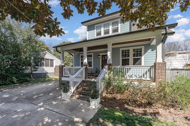 view of front of property featuring covered porch and fence