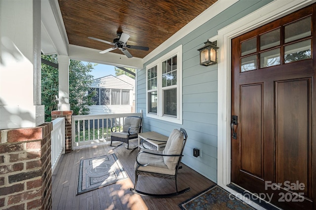 wooden deck featuring a porch and a ceiling fan