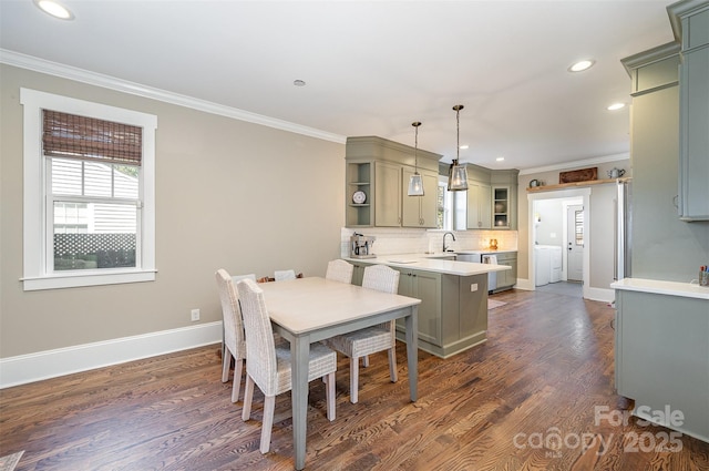 dining area with plenty of natural light, dark wood-style flooring, and ornamental molding