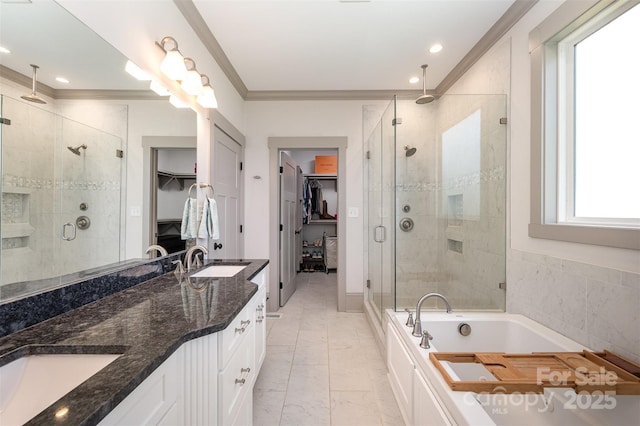 full bathroom featuring a sink, a shower stall, crown molding, double vanity, and a bath