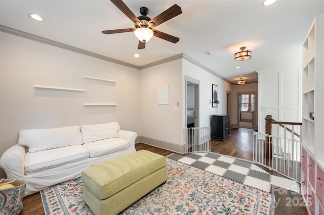 living area featuring recessed lighting, baseboards, dark wood-style floors, and ornamental molding