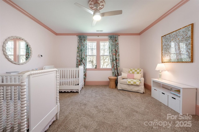 unfurnished bedroom featuring carpet floors, baseboards, ceiling fan, and ornamental molding