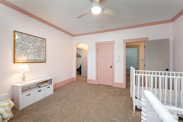 bedroom with baseboards, arched walkways, carpet floors, and ornamental molding