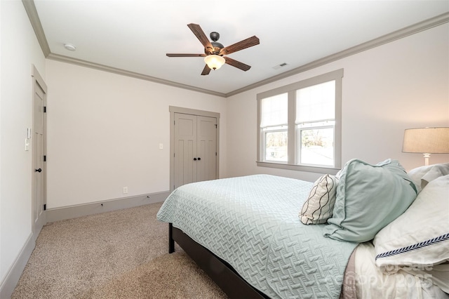 carpeted bedroom with visible vents, baseboards, and crown molding