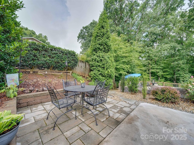 view of patio / terrace with outdoor dining space and fence