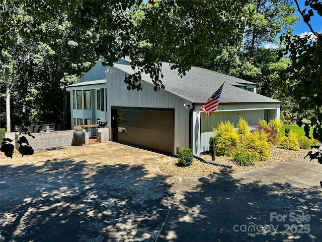 18 Pickett Ave, Spencer, NC 28159 - view of front of house featuring a shingled roof, an attached garage, and driveway