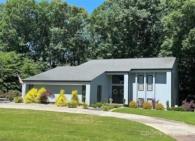 18 Pickett Ave, Spencer, NC 28159 - mid-century inspired home featuring a front lawn and roof with shingles