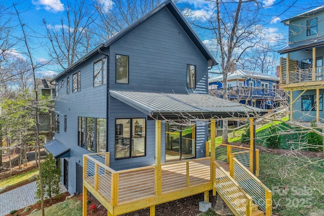 rear view of property featuring a standing seam roof and metal roof